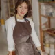 Confident entrepreneur crafts woman in pottery studio looking at camera